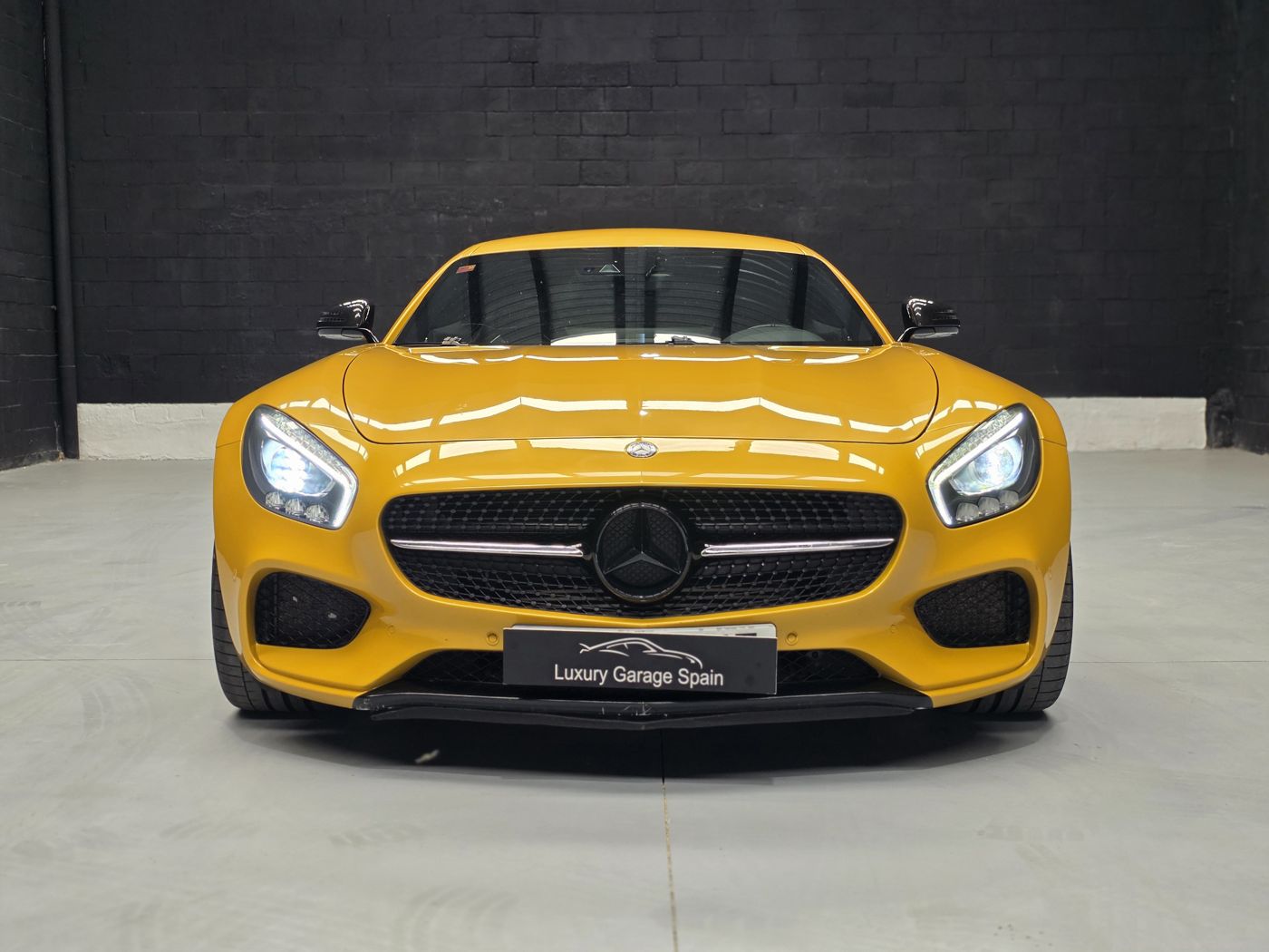 Mercedes-AMG GT amarillo, frontal con faros encendidos