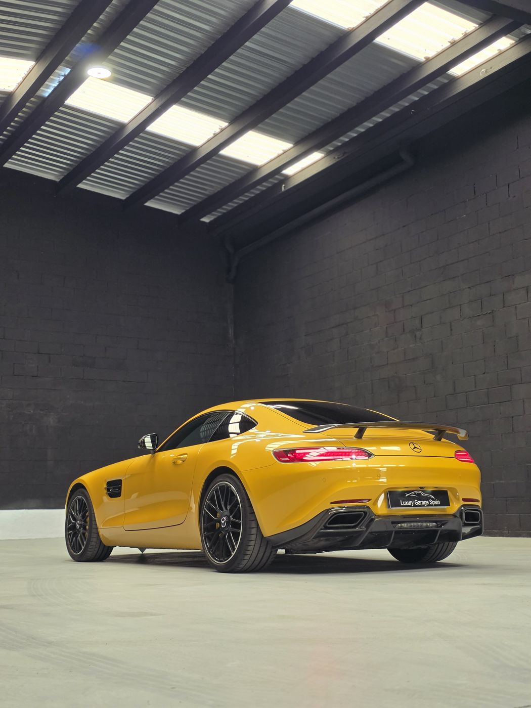 Mercedes-AMG GT amarillo, trasera tres cuartos en el garaje